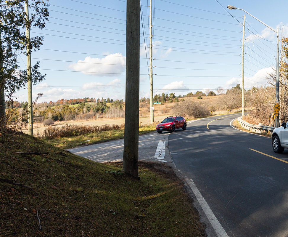 Leslie and Vandorf sideroad showing the area where a raised portion of a hill has been removed